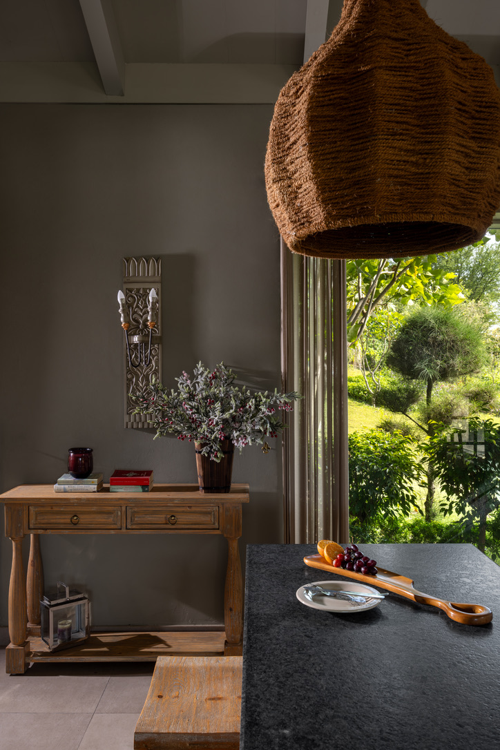Rustic wood console with a woven pendant lamp